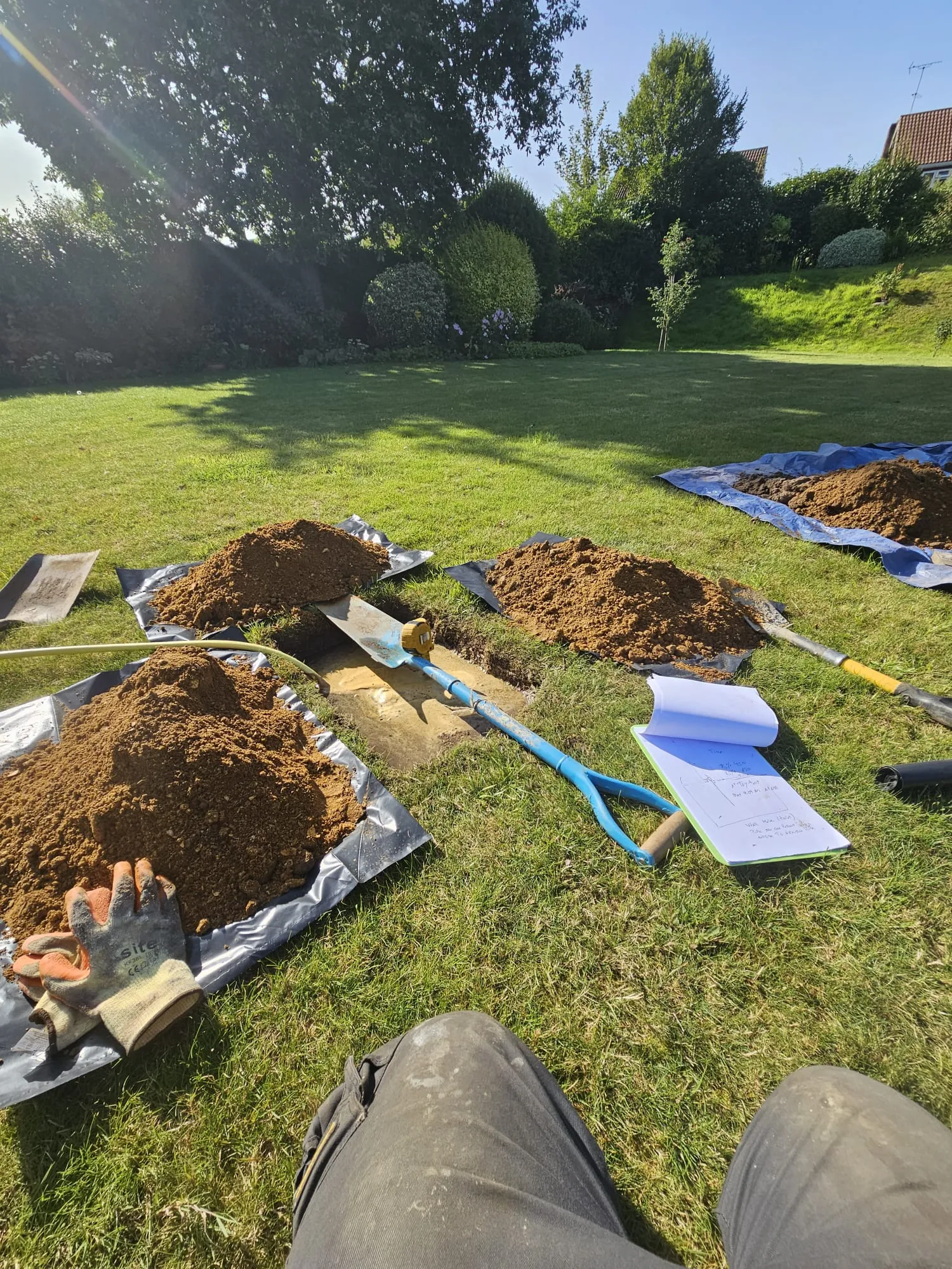 Groundworks in a garden for drainage or septic tank installation