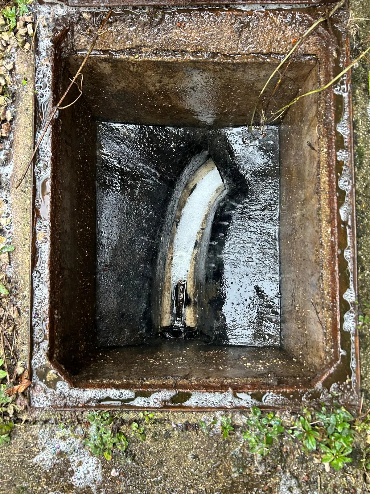 Blocked outdoor gully with standing water