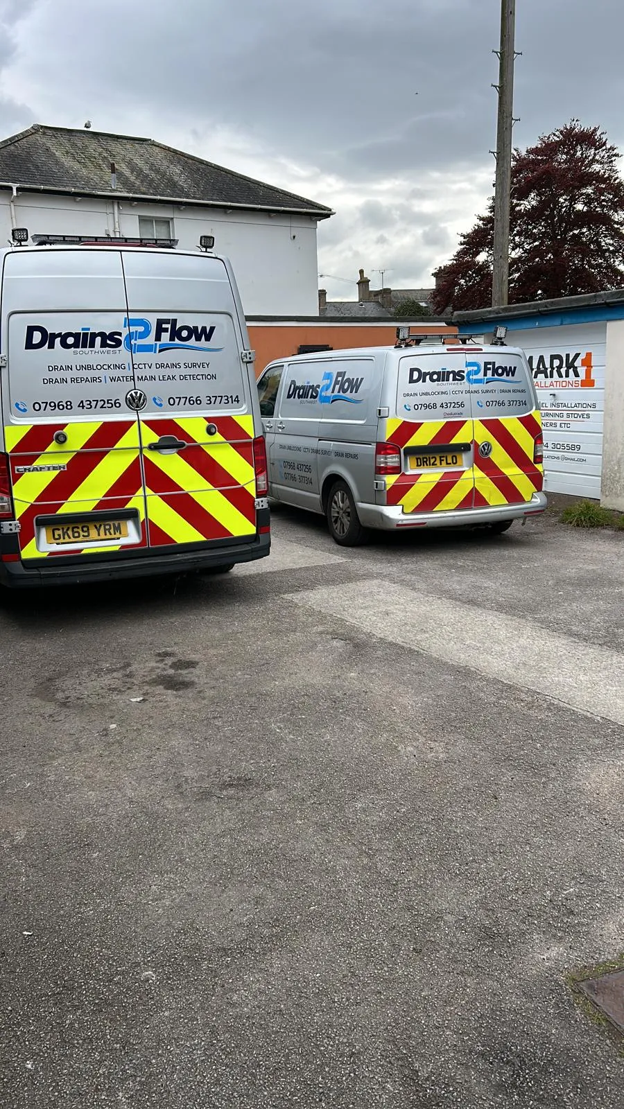 Two Drain 2 Flow Exmouth service vans with company branding, parked and ready for emergency drainage call-outs in the local area.