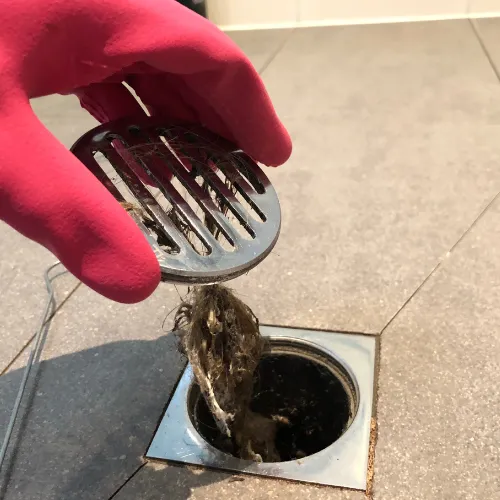 Hair and debris clog pulled from blocked shower drain