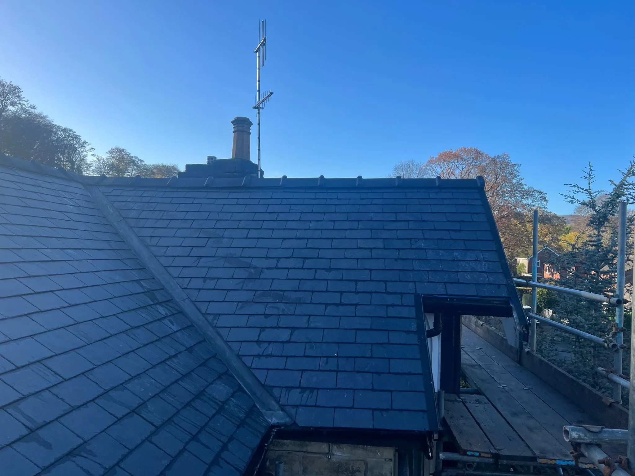 New slate roof tiles with lead work and chimney