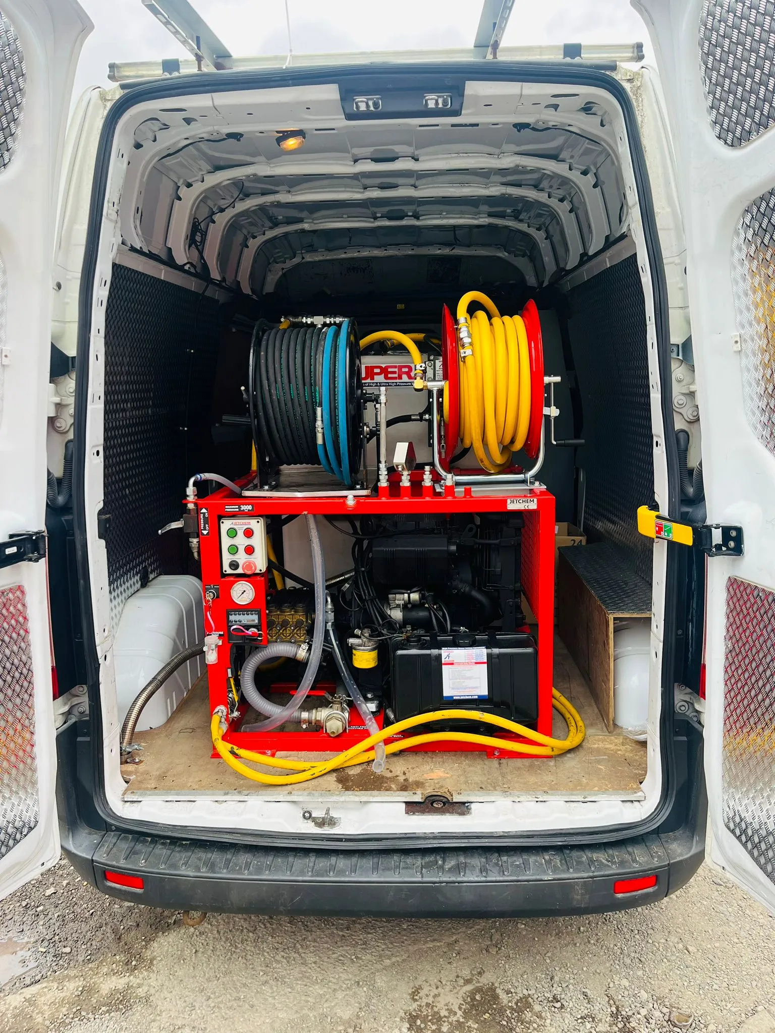 High-pressure drain jetting machine inside a Go-Flow Drainage Solutions van