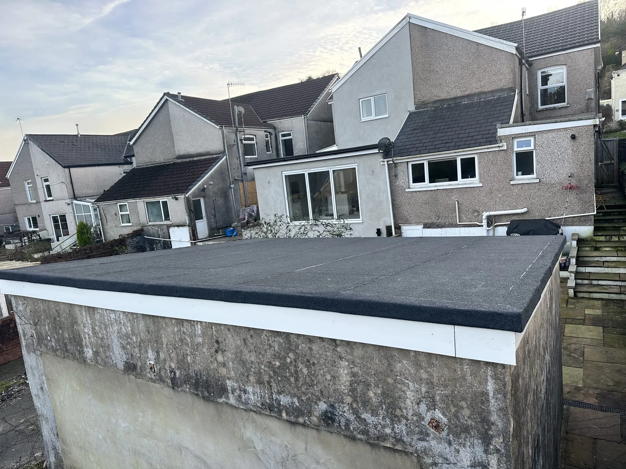 New flat roof installation on a residential garage or extension.