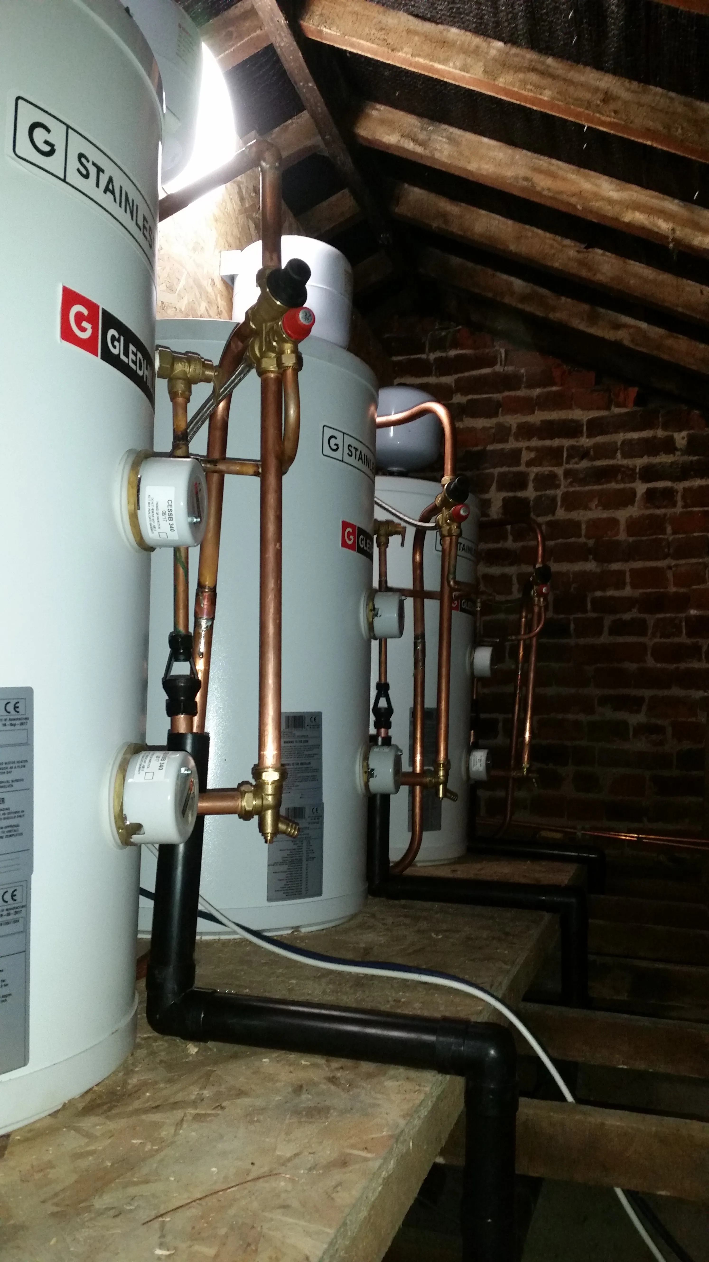 Installation of Gledhill unvented hot water cylinders in a loft by a plumbing and heating expert.