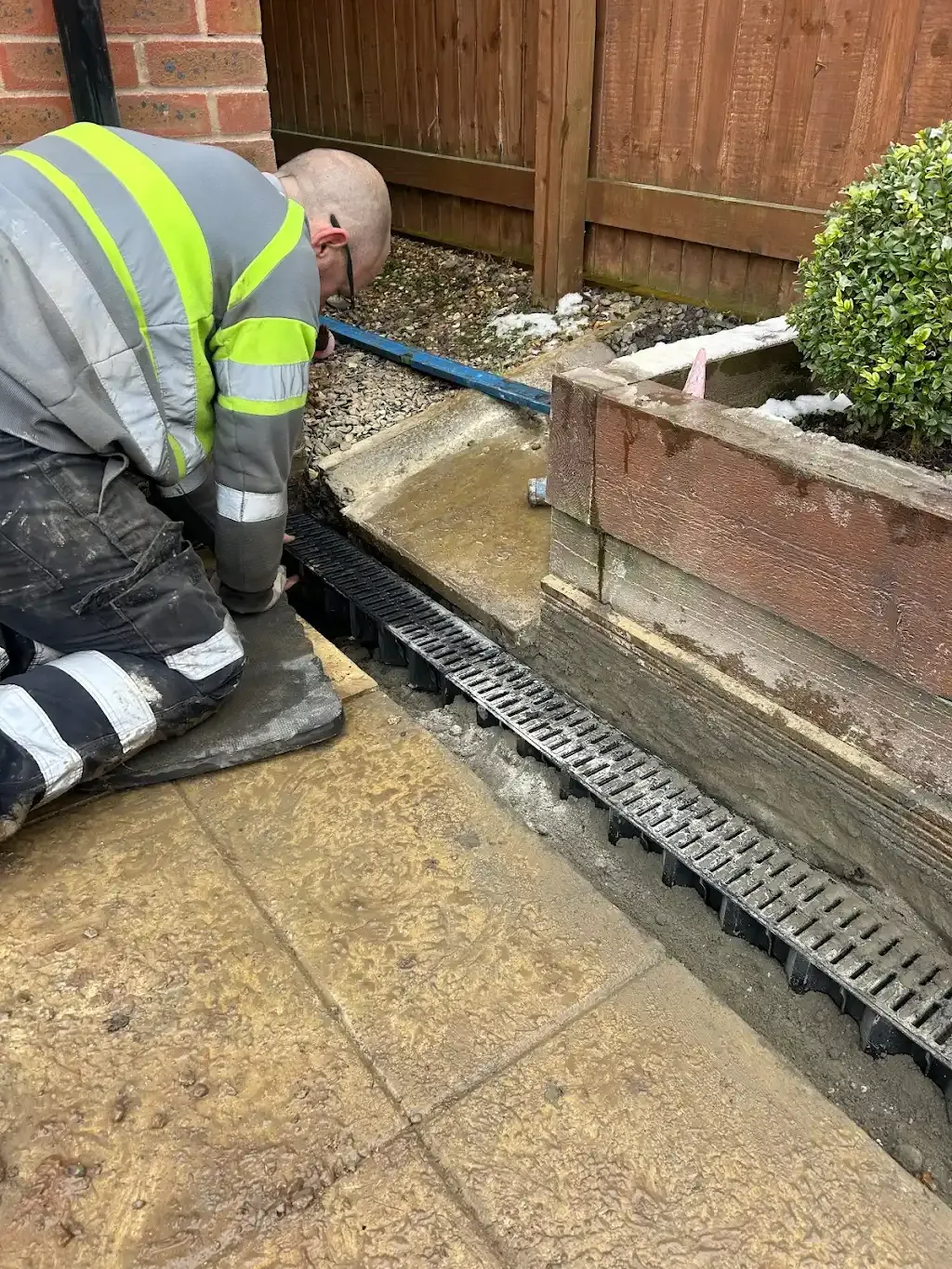 Drainage expert installing a new Aco drain for surface water management