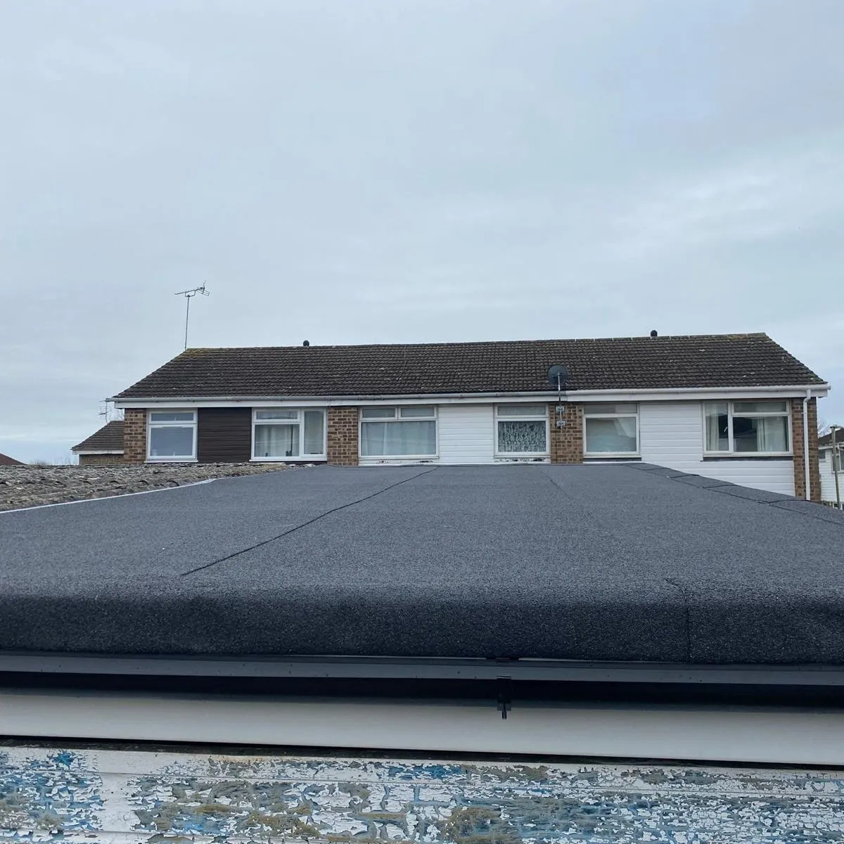 A professional torch-on felt flat roof installation by Century Roofing and Building.