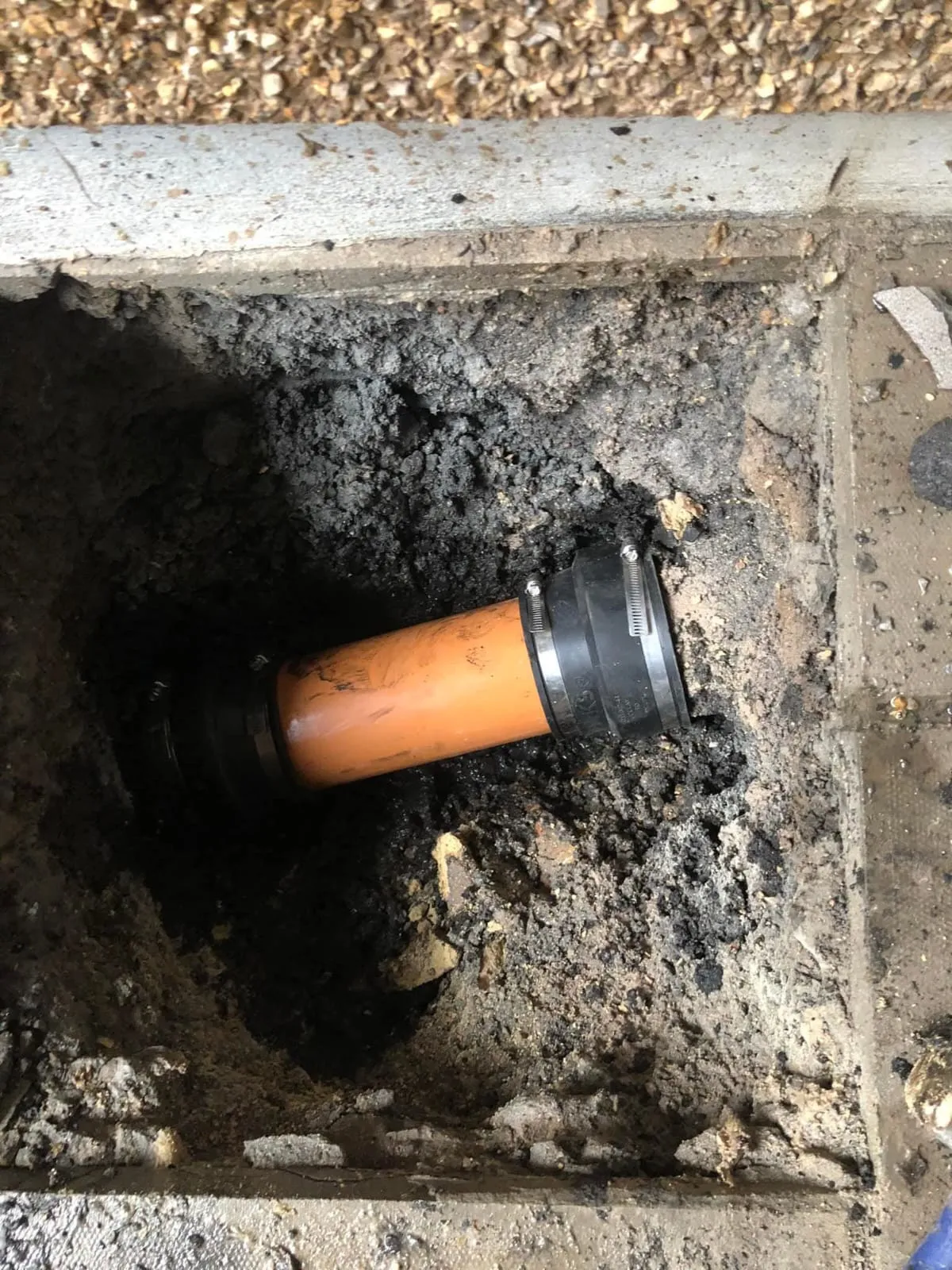 Underground drain pipe repair with coupling.