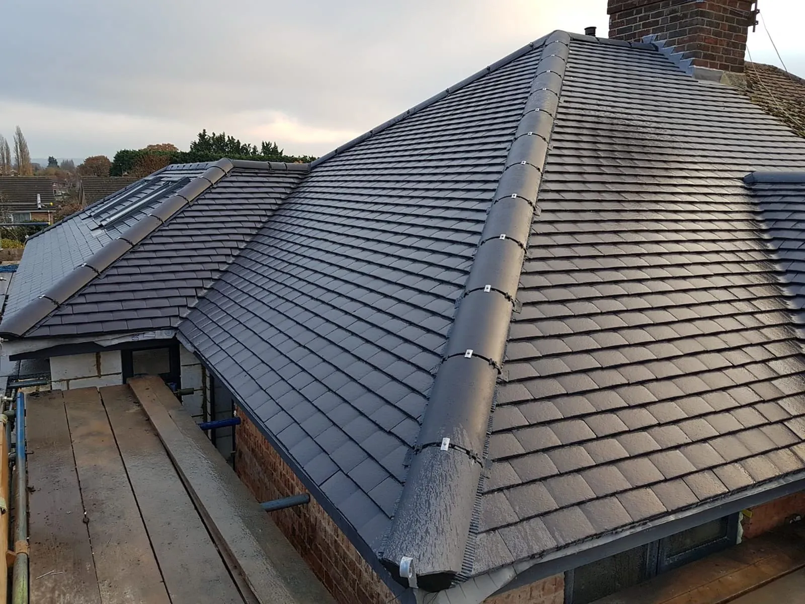 Newly installed grey tiled pitched roof with velux windows by local roofers in Haywards Heath, West Sussex.