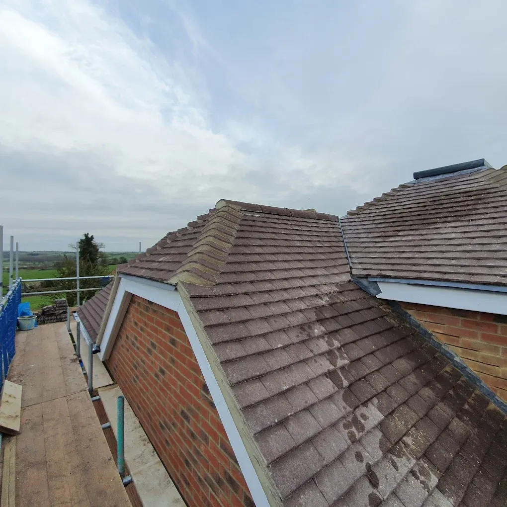 Re-roofing or new tiled roof installation project by Ox Roofing Ltd in Oxfordshire, showing scaffolding and brown concrete tiles.