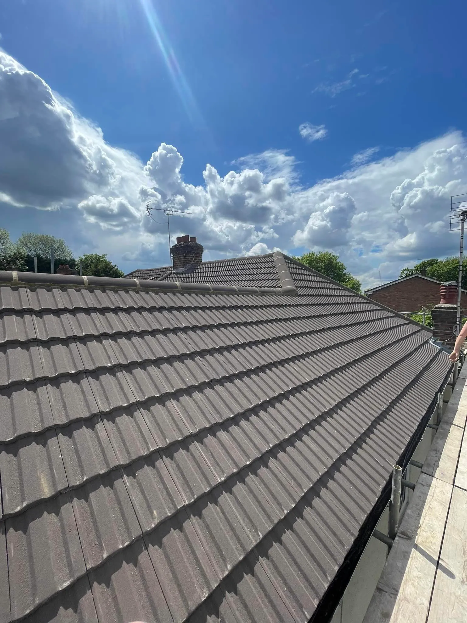 Newly installed concrete tiled pitched roof by Toptile Roofing Specialists Ltd