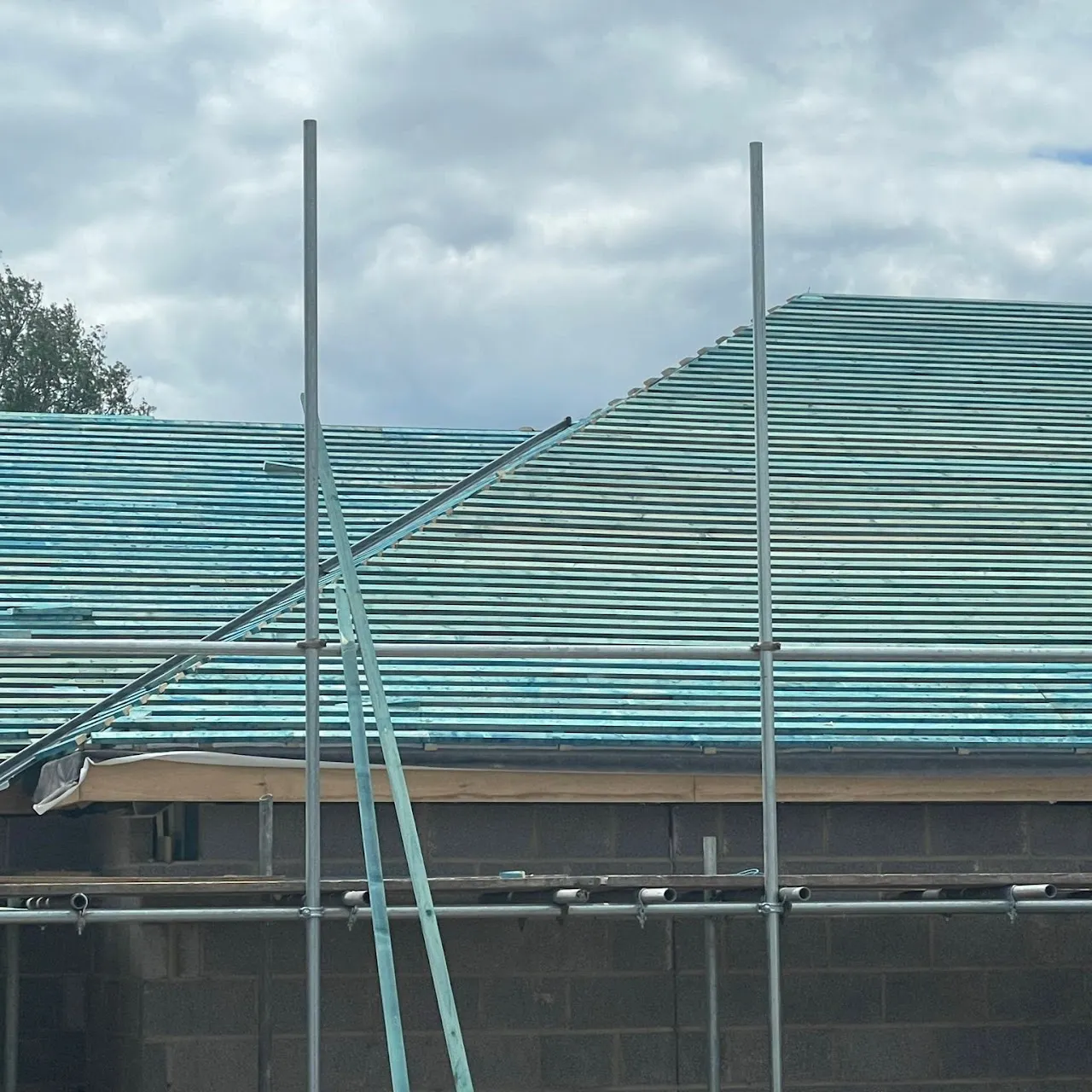 Professional new roof installation showing timber battens and scaffolding on a Kent home.
