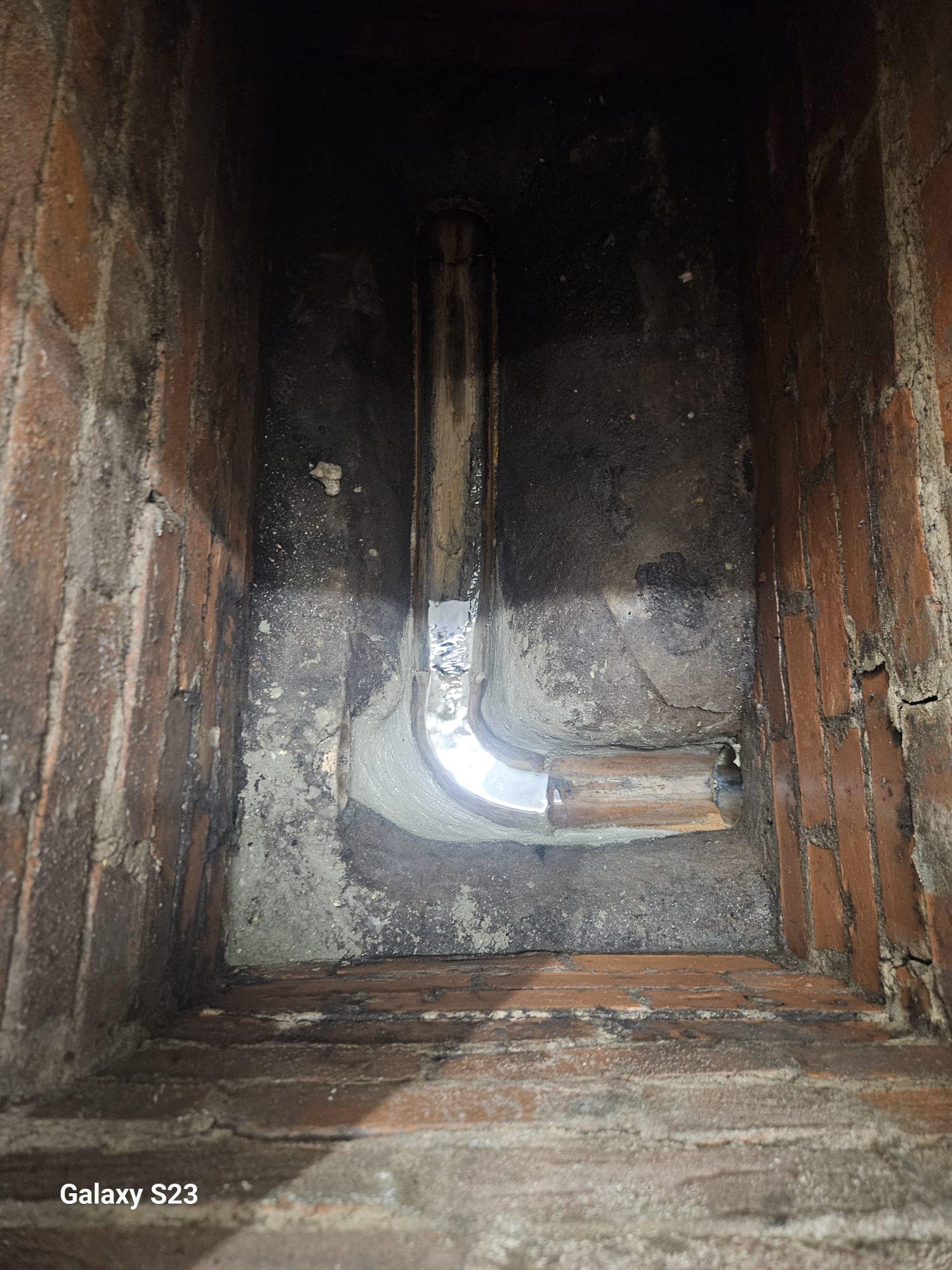 Drainage pipe within a brick inspection chamber or gully