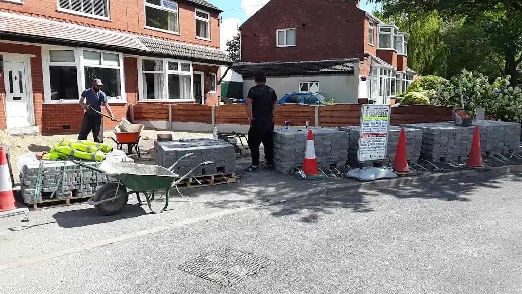 Workers laying block paving for a new driveway installation