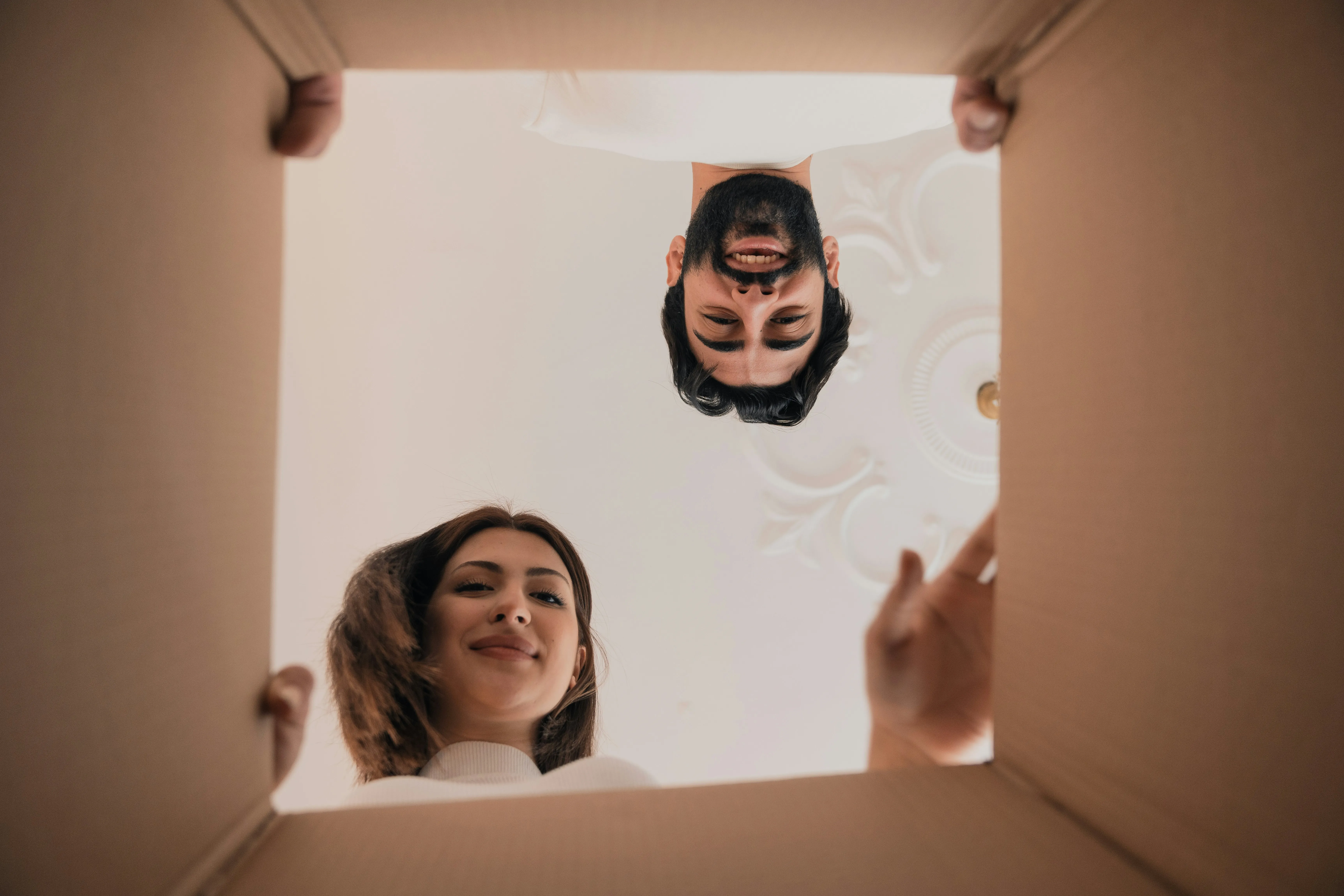 Happy couple looking into a moving box | Professional packing and unpacking services