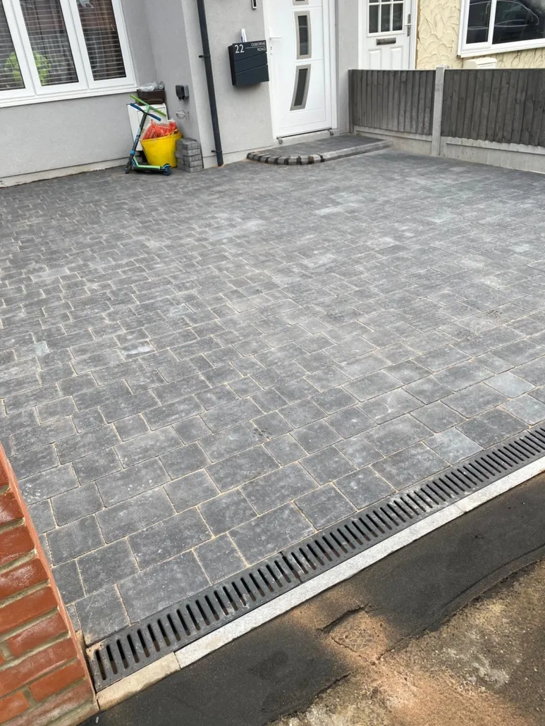 Newly installed grey block paved driveway with drainage
