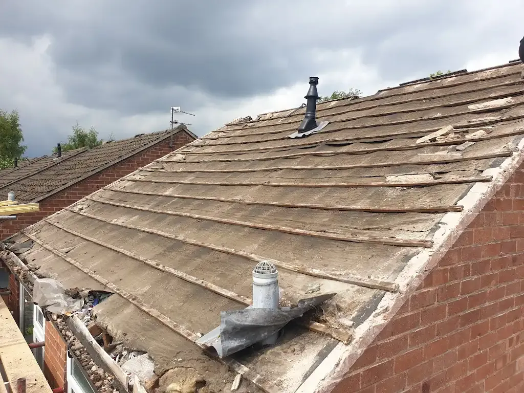 A picture of a damaged tiled roof in need of repair.