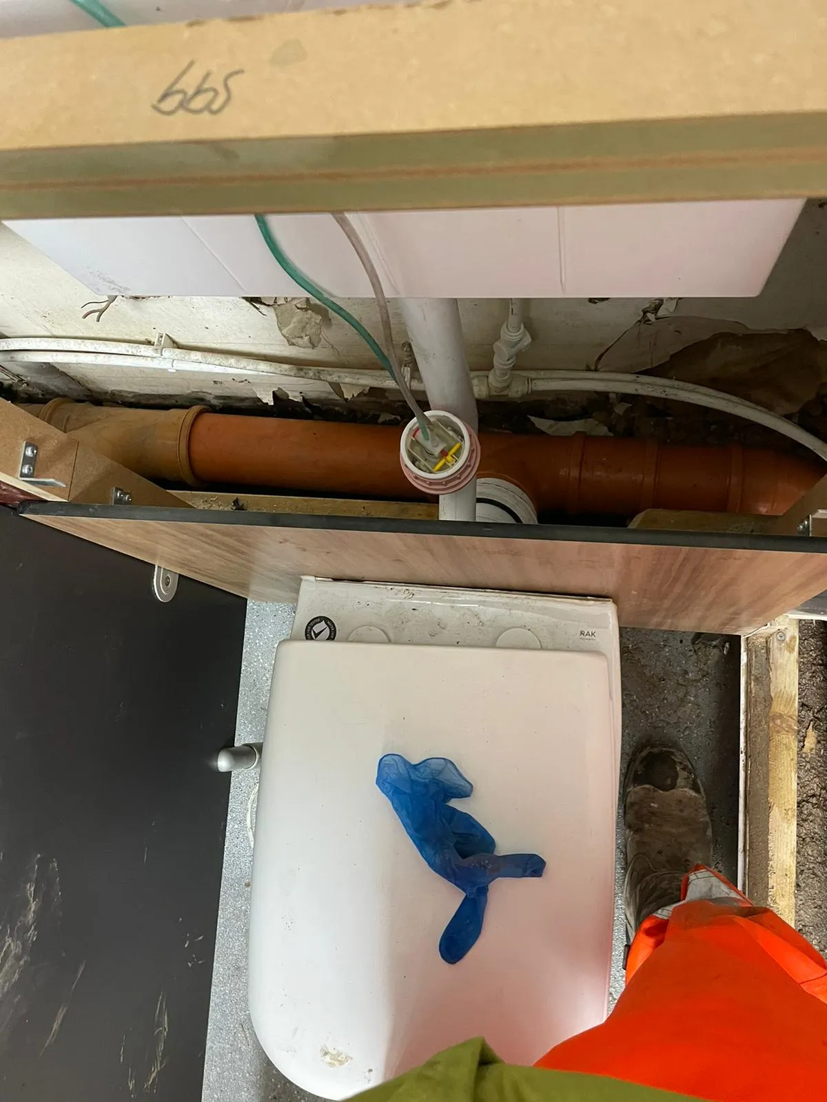 Drainage pipes and a toilet during a domestic installation or repair by a professional.