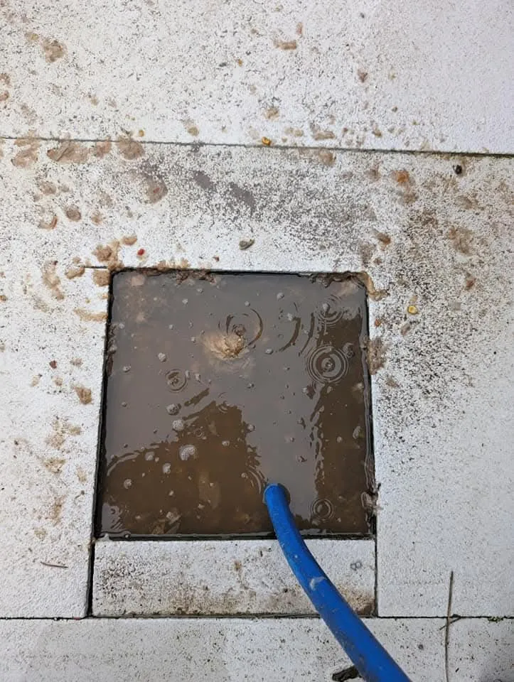 Blocked drain being cleared with a jetting hose