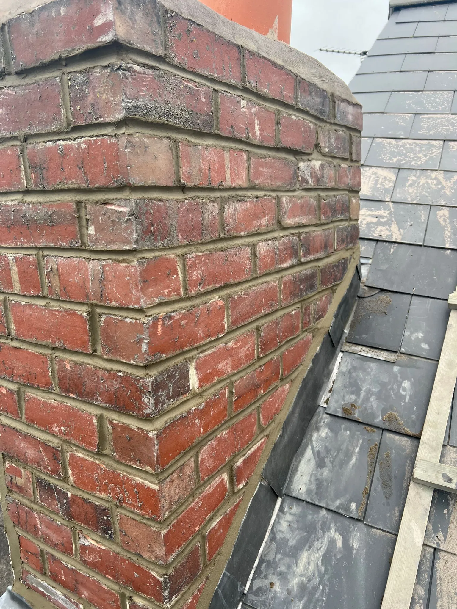 Expert chimney repair showing repointed brickwork and new lead flashing in Sheffield