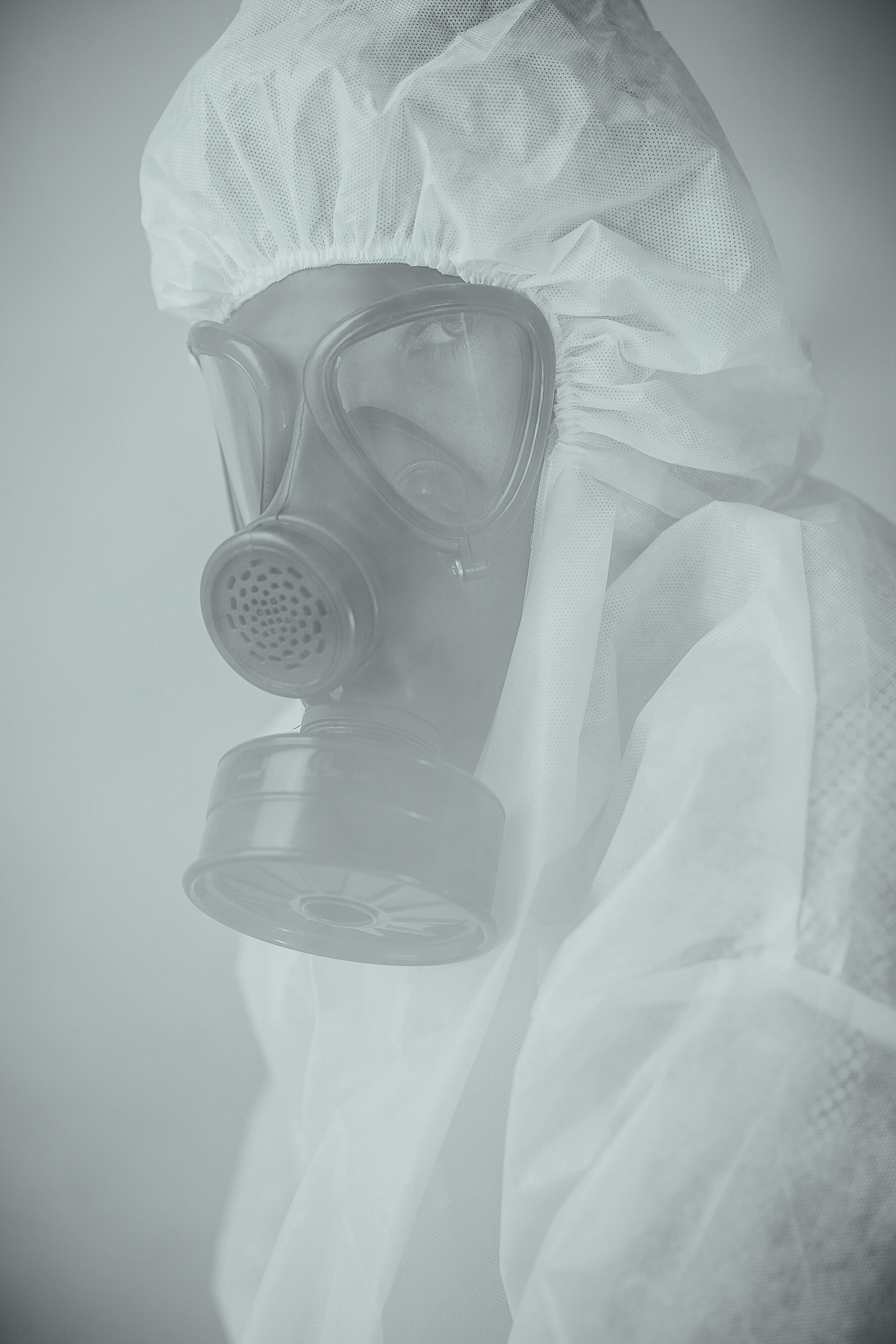 Expert wearing a protective suit and gas mask for asbestos work.