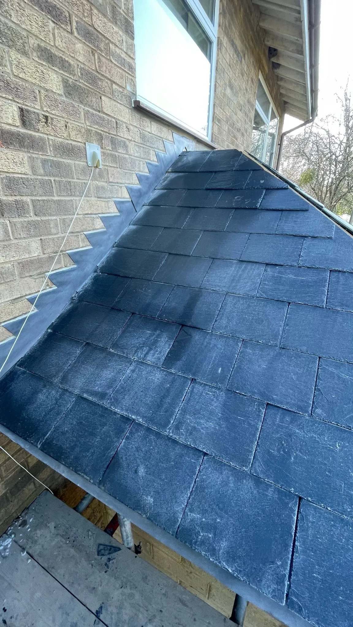 High-quality slate roofing and lead flashing installation by DP Carpentry and Building LTD on a home extension.