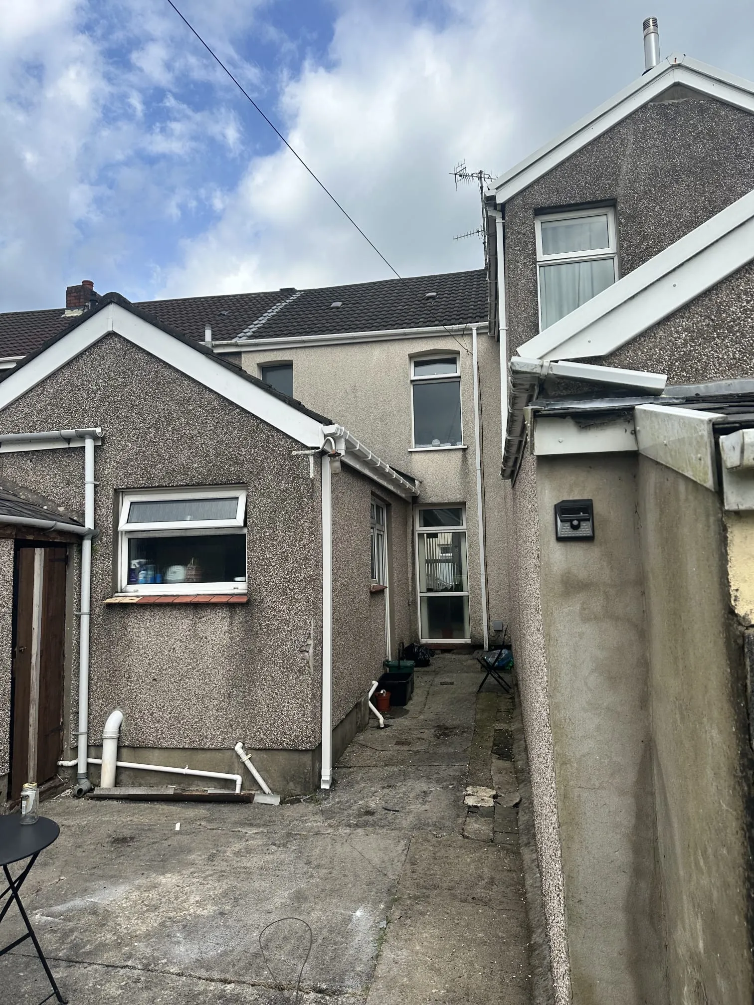 Exterior of residential houses showing roofs, guttering, fascias, and soffits.