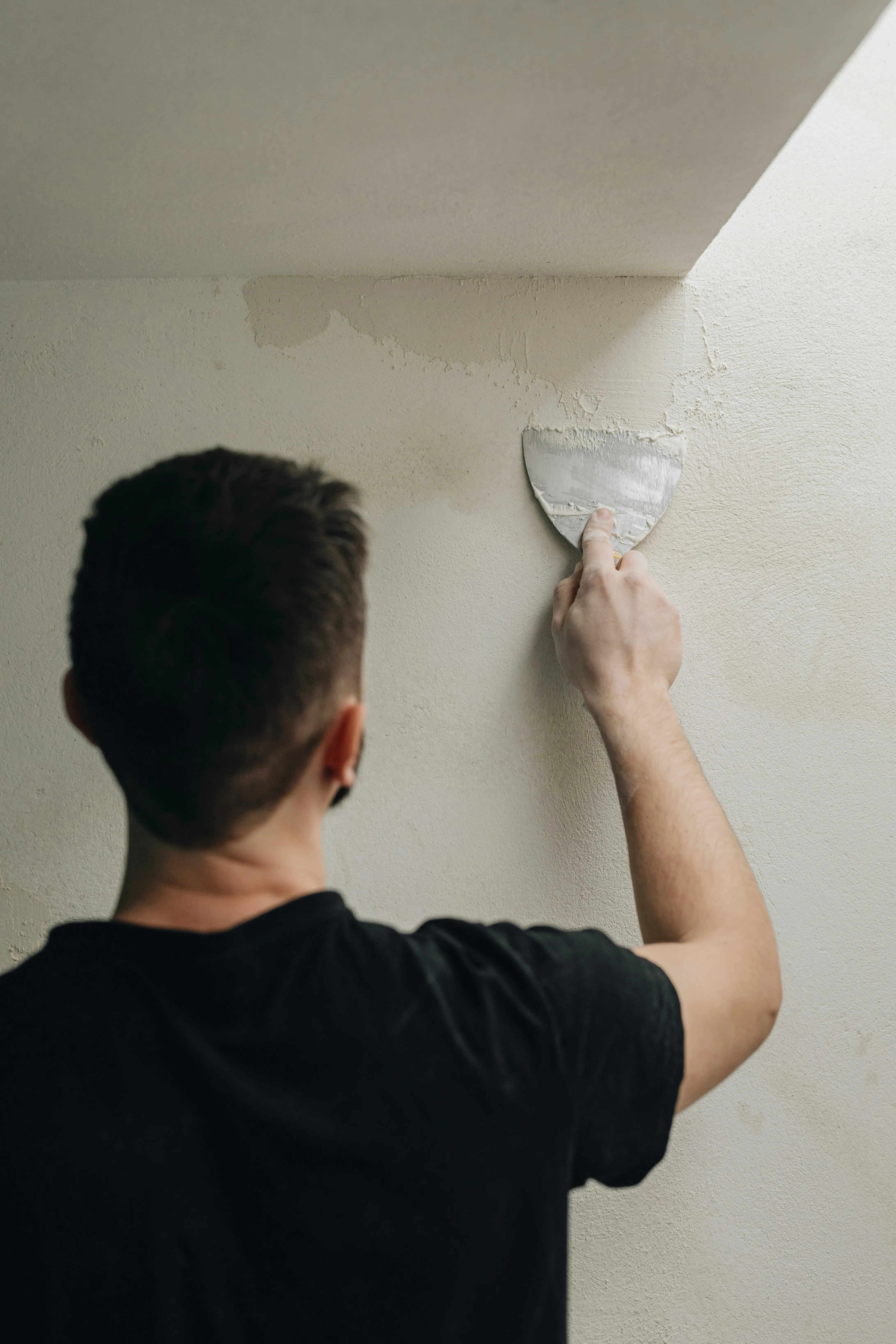 Professional applying plaster or render to a wall
