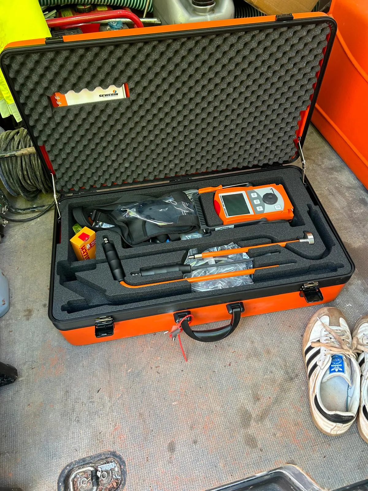 Sewerin leak detection and pipe locating equipment in an orange case