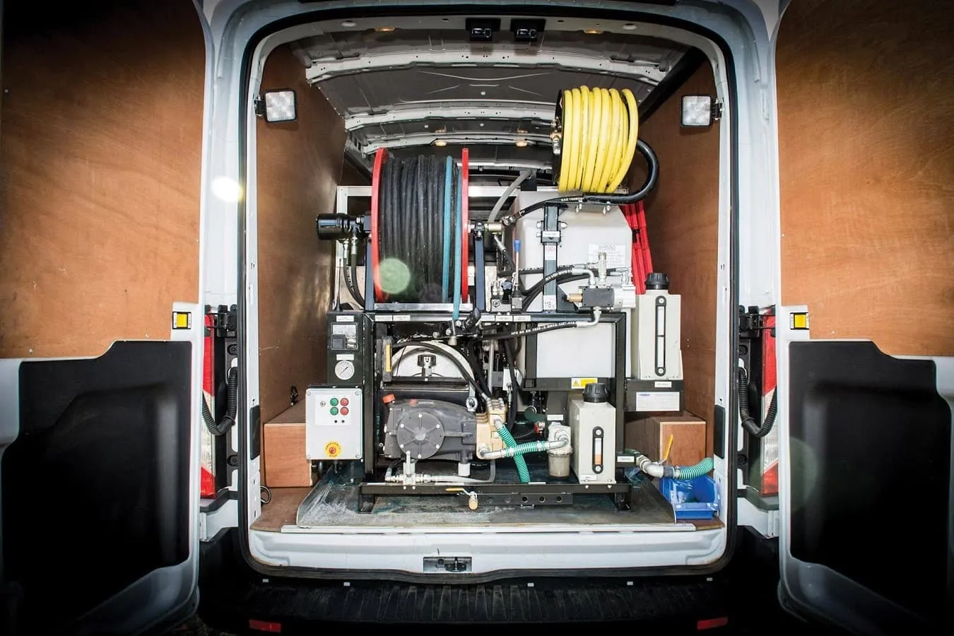 Drain Medics service van equipped with powerful drain jetting and unblocking equipment, including coiled hoses and a water tank.