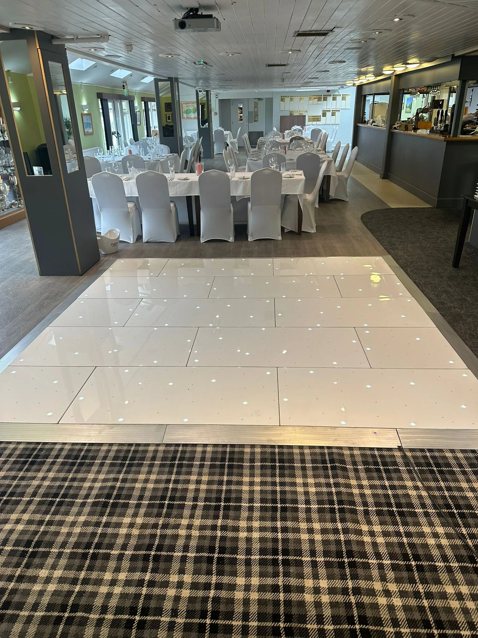 White LED starlit dance floor in a spacious wedding hall