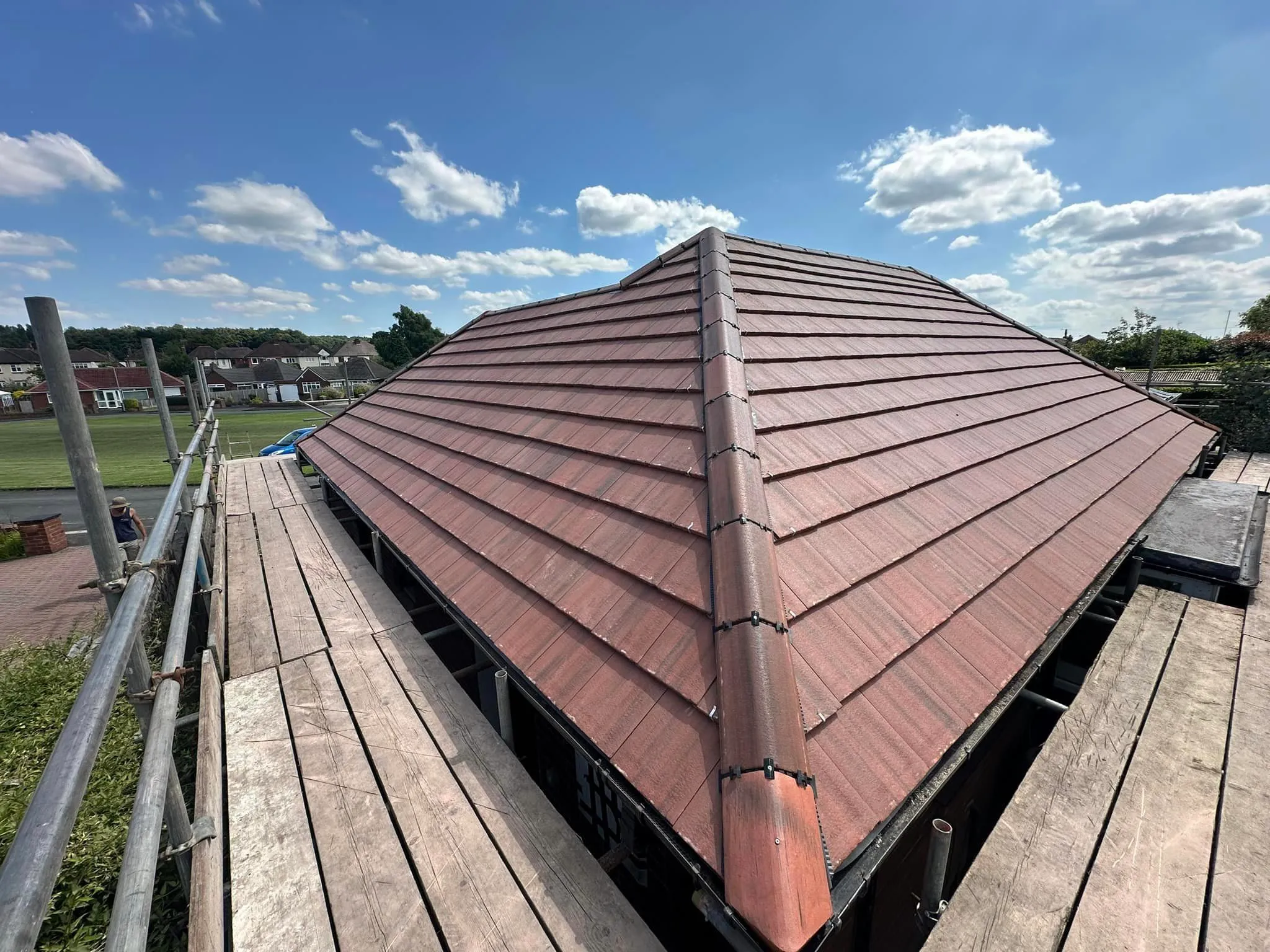 Professional new pitched roof installation underway with red roof tiles and scaffolding by Toptile Roofing Specialists.