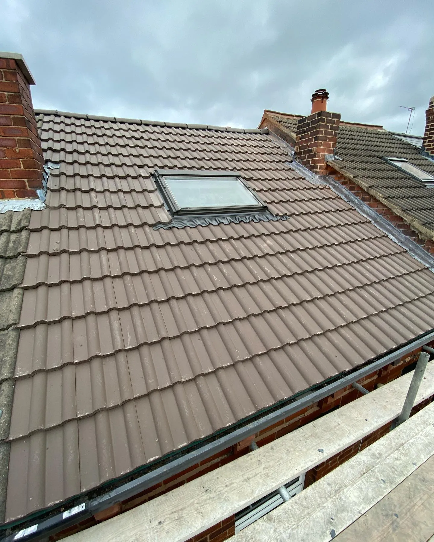 New pitched tiled roof installation with skylight and chimneys by Toptile Roofing Specialists in Plymouth.
