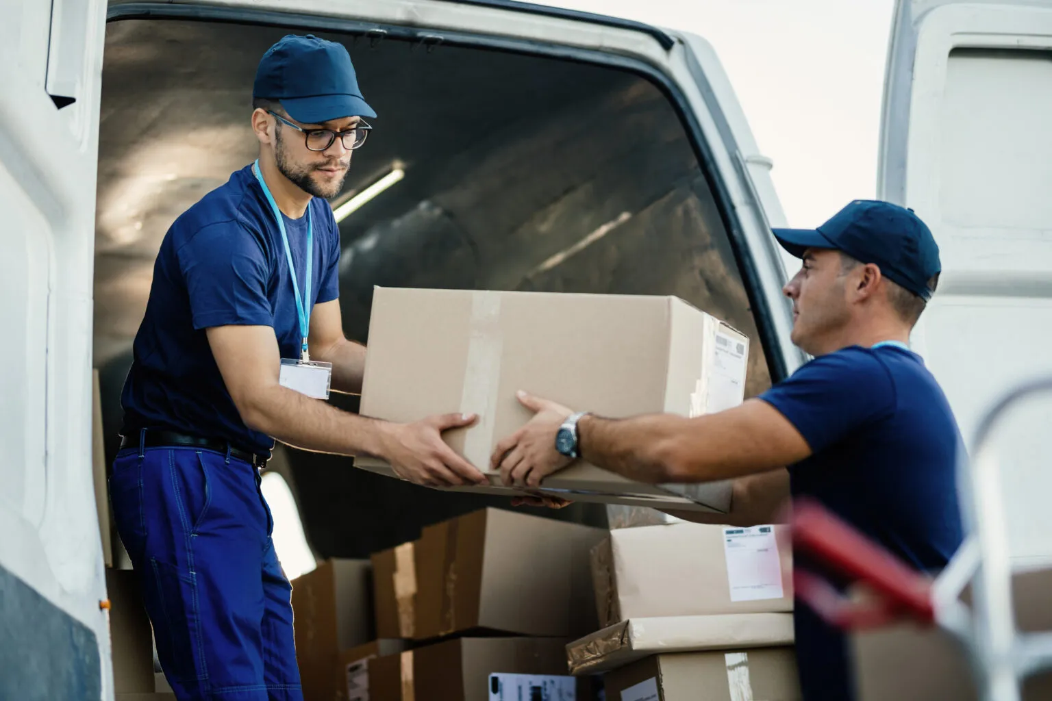 Professional London movers loading a box into a moving van for house removal service