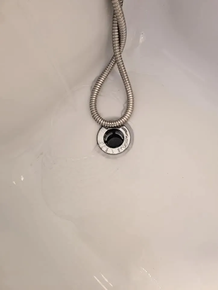 Slow draining or blocked bath drain with pooling water