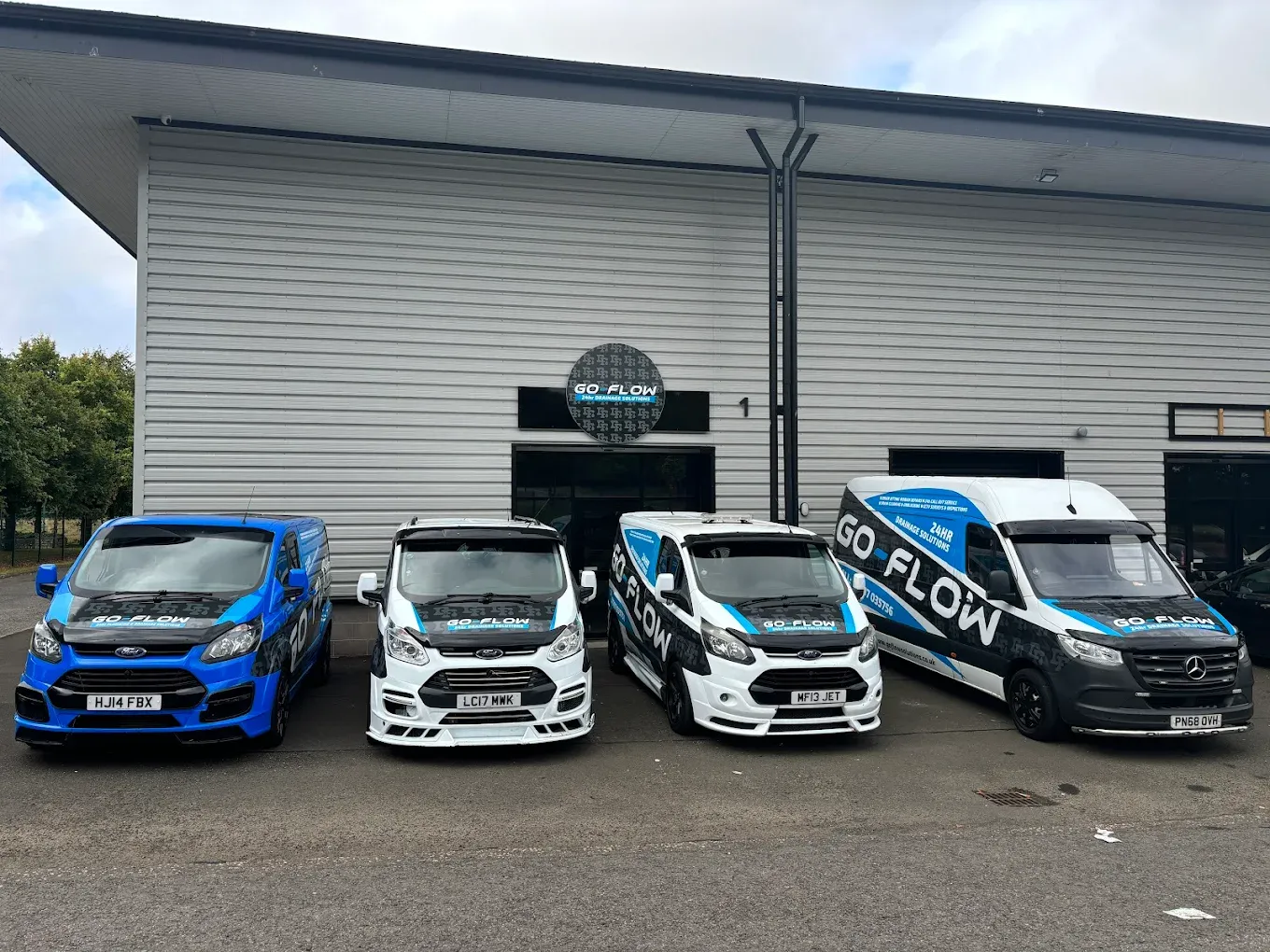 GO-FLOW DRAINAGE SOLUTIONS LTD branded service vans parked, representing the company fleet.