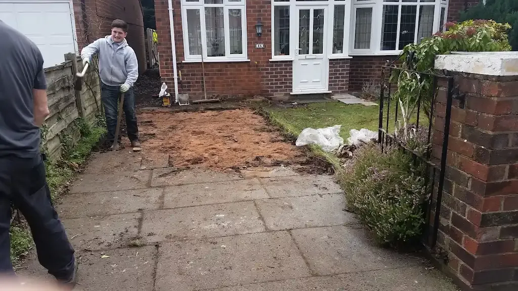 Workers excavating ground for a new driveway