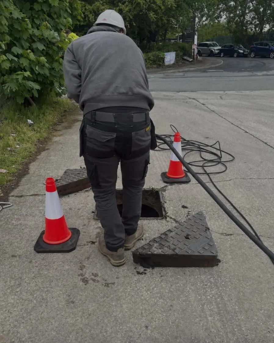Fast Drainage Northwest engineer performing commercial drain jetting on a public street
