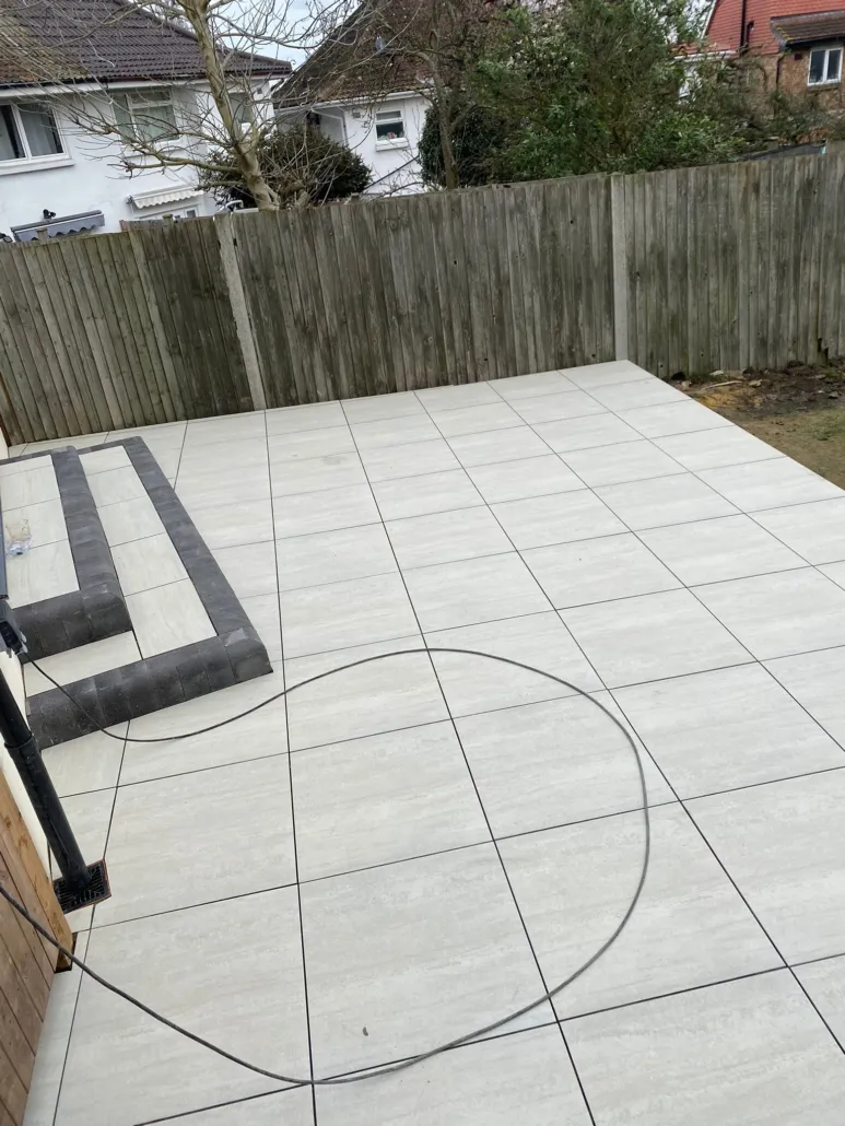 New patio with large paving slabs and steps.