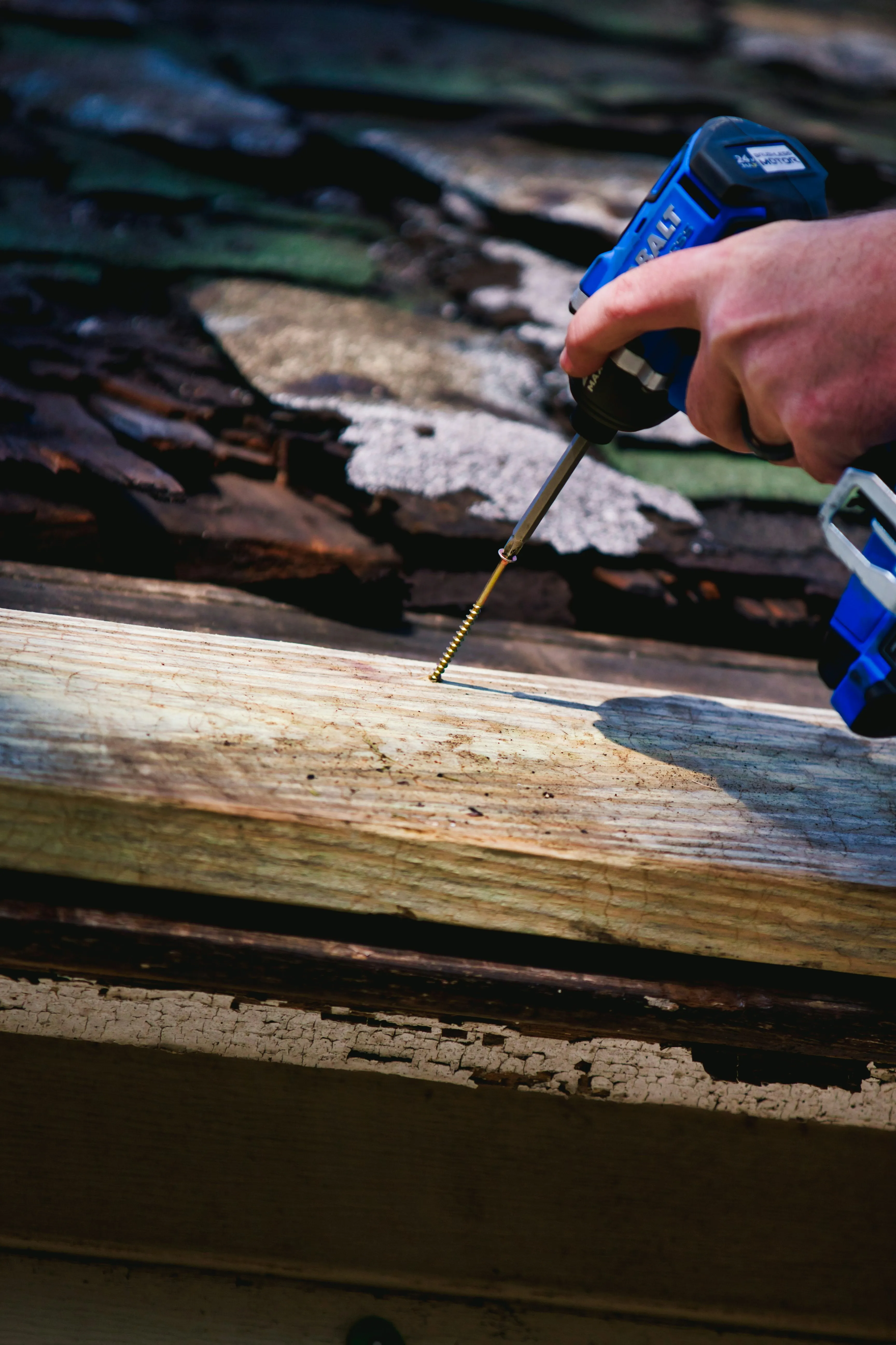 Professional roofer installing new roofing battens during a repair or new roof installation, demonstrating meticulous workmanship.