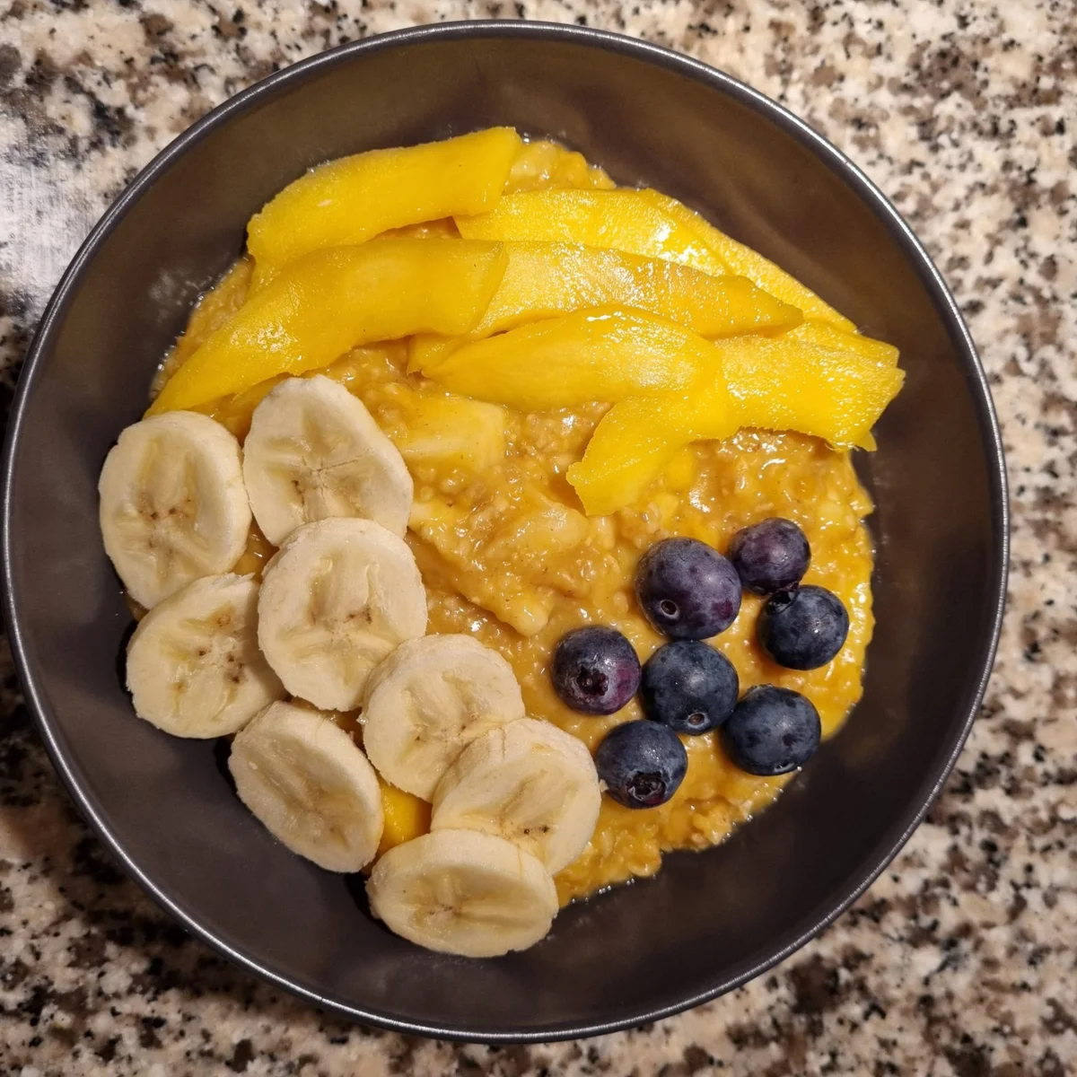 Yellow Porridge with Mango, Banana, and Blueberries Recipe - Rocely
