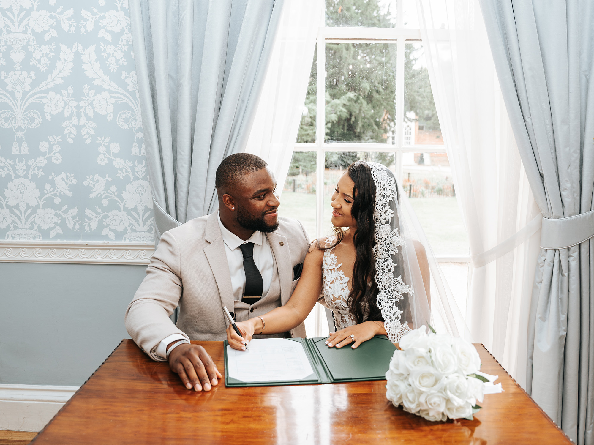 Bride and groom signing the register