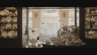 A bull rampaging in a shop selling fine china