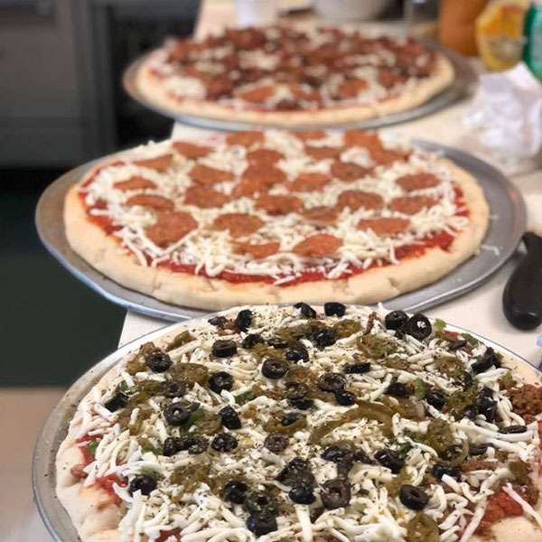 Pizzas lined up in the Butchies kitchen