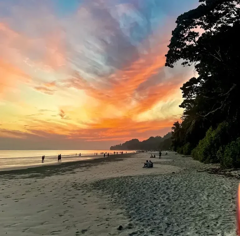 Twilight glow along Radhanagar Beach with gentle surf