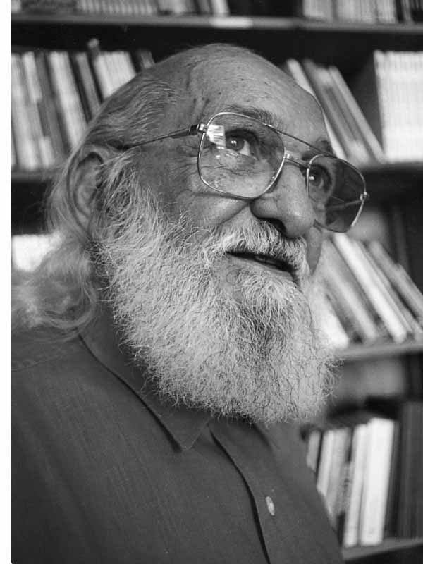Elderly man with beard and glasses in front of bookshelf for Other e-reader wallpaper or screensaver featuring portrait and elderly and more