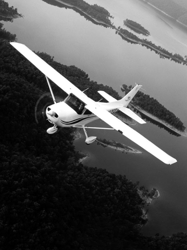 Small airplane flying over a lake and forest for Other e-reader wallpaper or screensaver featuring airplane and flight and more
