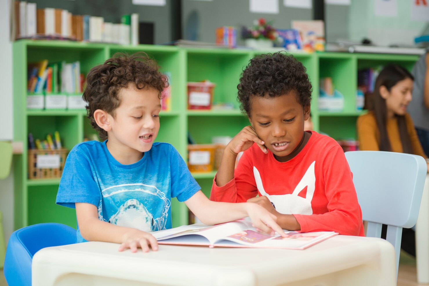 A young child engaged in a hands-on learning activity in a Canadian kindergarten classroom.