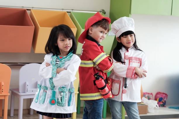 Kids exploring career planning through role-play activities, pretending to be doctors, chefs, and firefighters.