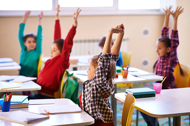 Elementary school students participating in a classroom activity with their teacher in a U.S. public school.