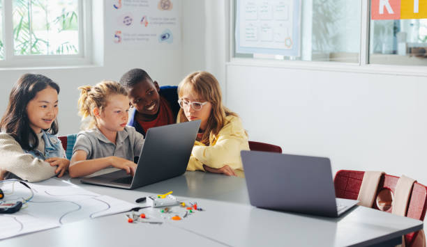 Public school students using digital devices for online learning and personalized education in a technology-enhanced classroom.